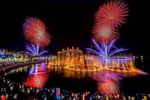Fireworks reflected over water at a festival